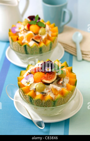 Stuffed melon with yogurt and figs. Recipe available. Stock Photo