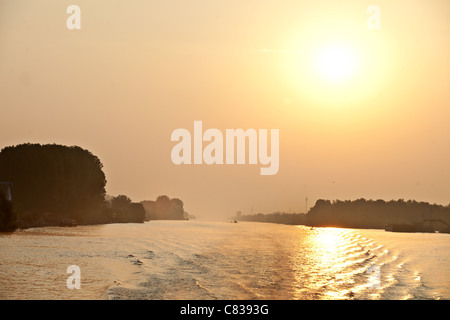 Sunrise over Sulina channel branch of Danube Delta, Romania Stock Photo