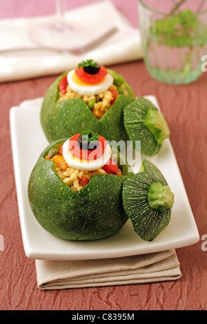 Stuffed courgettes with rice salad. Recipe available. Stock Photo