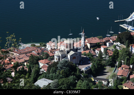 Laveno-Mombello and its two main churches, a stretch of Lake Maggiore and some boats. Text on top. Stock Photo