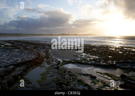 sunset over rocky shoreline at Enniscrone beach and killala bay county sligo republic of ireland Stock Photo