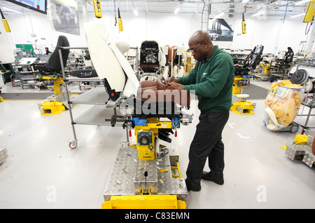 An employee works on Bentley motor car seats at the company's factory in Crewe, U.K. Stock Photo