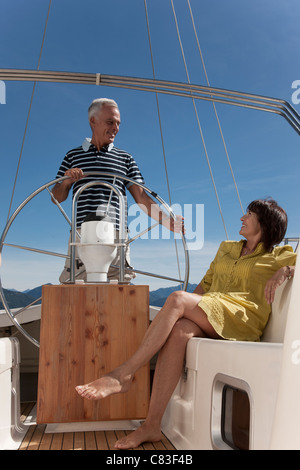 Older couple relaxing on sailboat Stock Photo