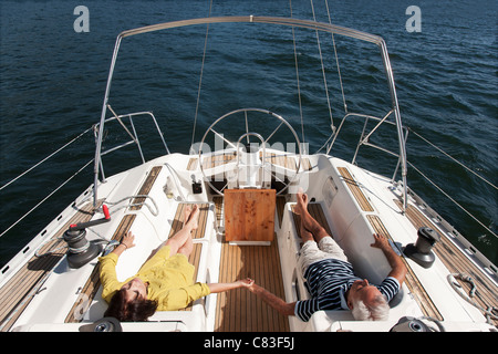 Older couple relaxing on sailboat Stock Photo