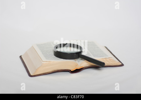 Magnifying glass on book Stock Photo