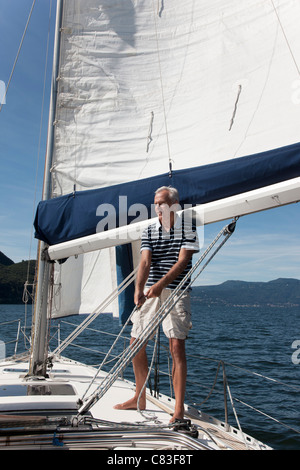 Older man sailing on lake Stock Photo