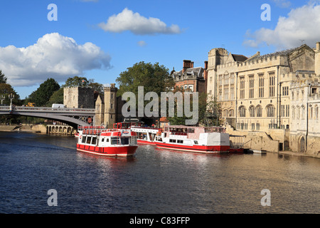 A pleasure boat takes tourists for a trip on the river Ouse, near Lendal Bridge, York, North Yorkshire, England Stock Photo