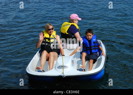 Three generations in a paddle boat in the Finger Lakes US. Stock Photo