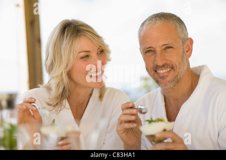 Couple in bathrobes having breakfast Stock Photo