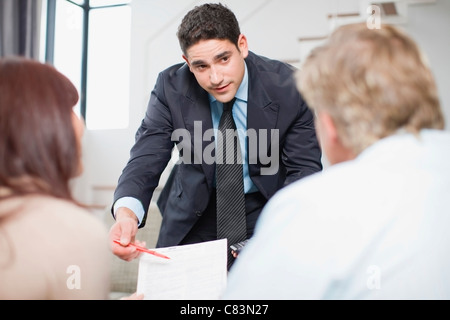 Businessman working with couple Stock Photo