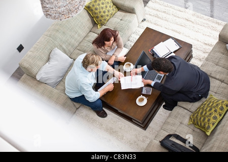 Businessman talking with couple Stock Photo