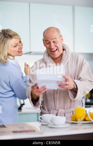 Surprised man reading mail Stock Photo
