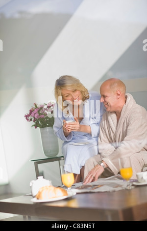 Couple in bathrobes having breakfast Stock Photo