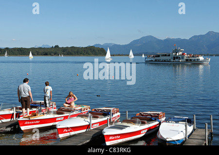 Tourists with Electo Boats and a Ferry Boat on the Chiemsee, Prien Stock Chiemgau Upper Bavaria Germany Stock Photo