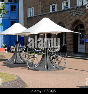 Elaborate unusual bike rack for parking bicycles outside London Hospital Students Hostel beneath parasol canopy Whitechapel East London England UK Stock Photo