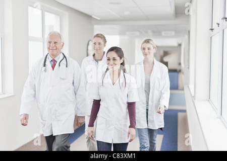 Doctors and nurses walking in hospital Stock Photo