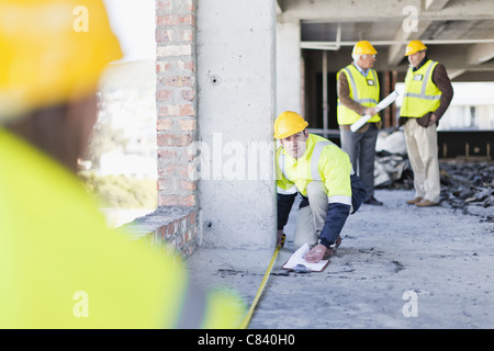 Worker measuring space on site Stock Photo