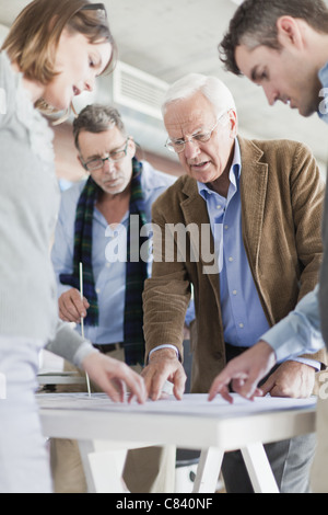 Architects reading blueprints in office Stock Photo