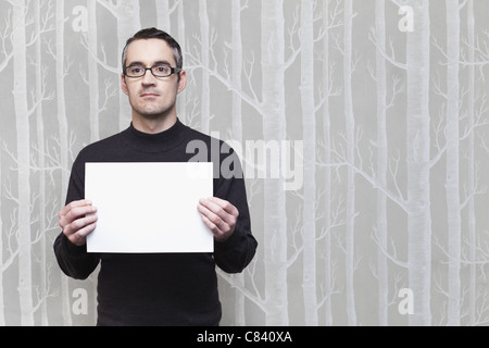 Businessman holding blank card Stock Photo