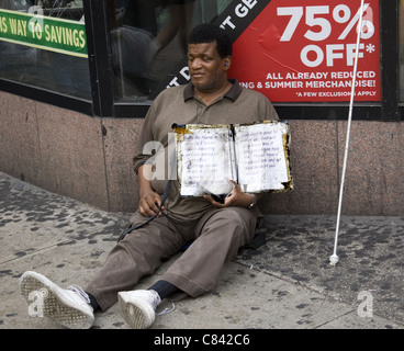 Blind man sits on 34th Street asking for charity. NYC. Stock Photo