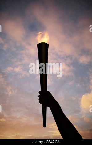 Hand holding flaming baton Stock Photo