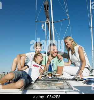 Family relaxing on sailboat Stock Photo