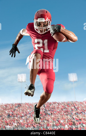 African American football player running with football Stock Photo