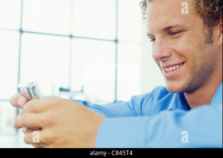 Smiling businessman using cell phone Stock Photo
