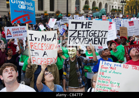 Protesters marching on Michigan Avenue, one wearing Guy Fawkes mask. Occupy Chicago protest. Stock Photo