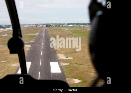 Cockpit view of airplane landing on airport runway Stock Photo