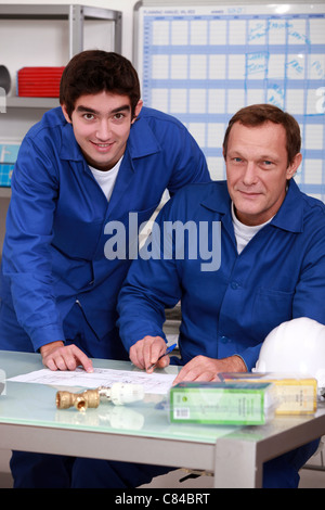 Two factory workers checking inventory Stock Photo
