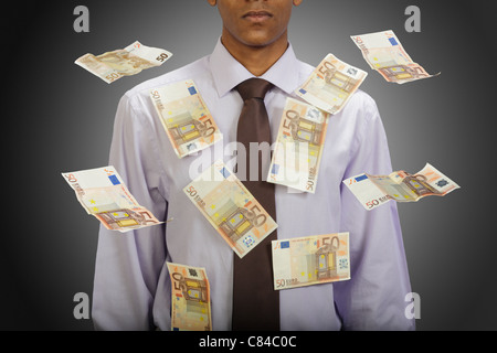 Euro notes flying around businessman Stock Photo