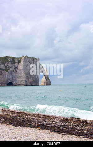 Scenic view of Etretat with its beach and famous cliffs with arches at ...