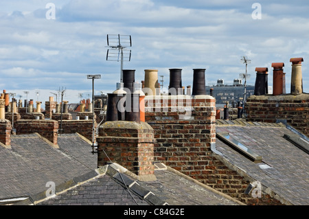 Close up of chimney chimneys pots and rooftops roof on terraced houses house York North Yorkshire England UK United Kingdom GB Great Britain Stock Photo