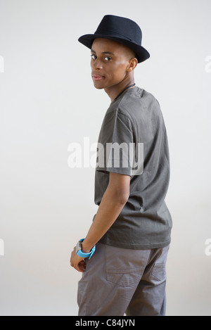 Young man in hat looking over shoulder, portrait Stock Photo