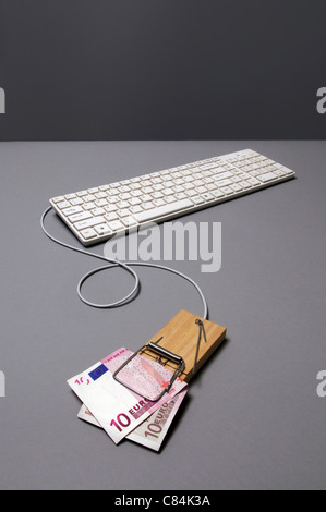 Euro banknote in mousetrap connected to keyboard Stock Photo