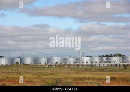 white tanks in tank farm with clouds in sky Stock Photo