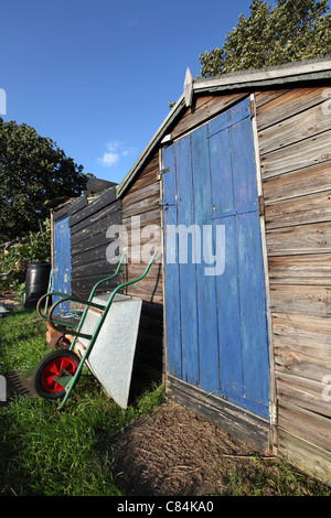 Ramshackle, garden shed on allotment, sunny with blue sky behind. Self-sufficiency, grow your own, recession living, outdoors Stock Photo