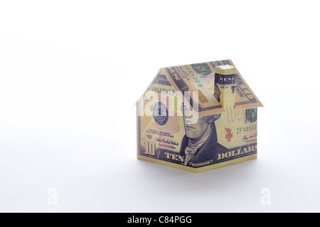 Model house folded with dollar bill Stock Photo