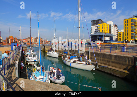 Yachts passing through the lock at Sovereign Harbour ,Eastbourne Marina, East Sussex, England, UK, GB Stock Photo