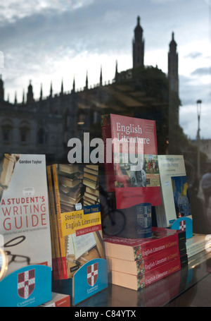 Reflections of Kings College Chapel in he window of Cambridge University Press Bookshop in Cambridge UK with books on display Stock Photo