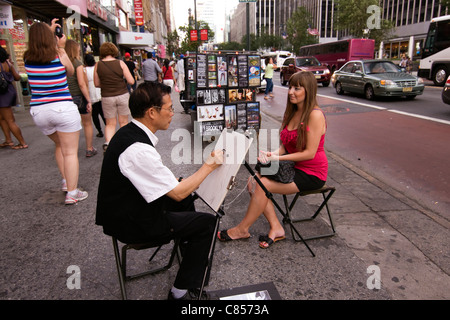 Street artist sketching a young woman's portrait on a 34th Street sidewalk in New York City Stock Photo