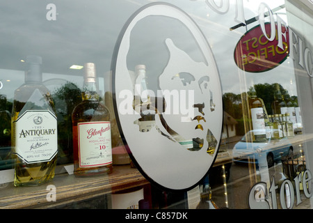 A graphic of Scottish national poet Robert Burns in a shop window, which sells whisky, in Burn's birthplace of Alloway, Scotland Stock Photo