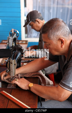 Tailor sewing a garment at Bukittinggi market. Bukittinggi, West Sumatra, Sumatra, Indonesia, South-East Asia, Asia Stock Photo