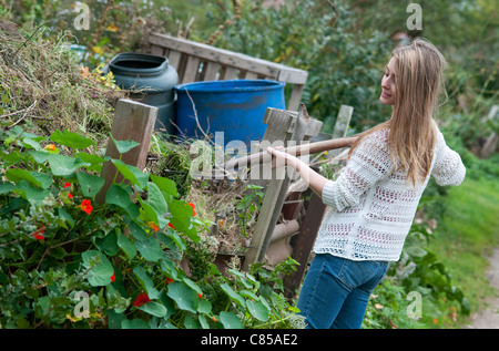 young female gardener working in urban allotment garden Stock Photo