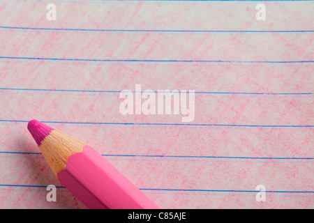 Pink color pencil with coloring on a piece of writing paper Stock Photo