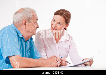 Man and Woman Discussing Paperwork Stock Photo
