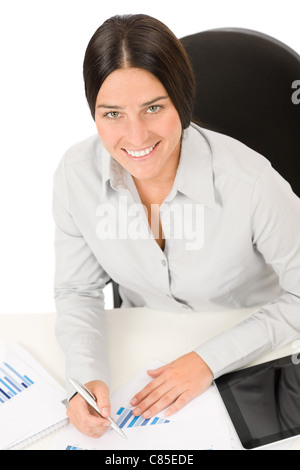 Successful business woman at office smiling working on charts Stock Photo