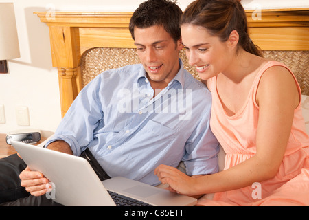 Couple using Laptop in Hotel Room, Reef Playacar Resort and Spa, Playa del Carmen, Mexico Stock Photo