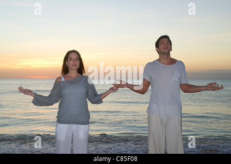 Couple Meditating on Beach, Reef Playacar Resort and Spa, Playa del Carmen, Mexico Stock Photo